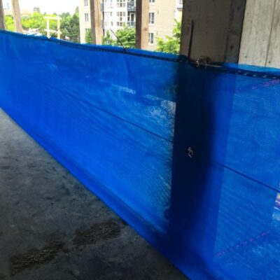 RopeRail with blue netting installed to protect the edge on a concrete building.